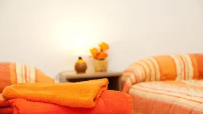 a living room with two chairs and a table at Rental in Rome Celeste Apartment in Rome