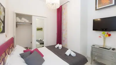 a bedroom with a bed with a television and a dresser at Consulta By Rental In Rome in Rome