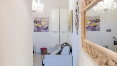 a living room with a couch and a chandelier at Consulta By Rental In Rome in Rome