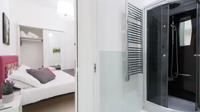 a room with a glass door leading to a bedroom at Consulta By Rental In Rome in Rome
