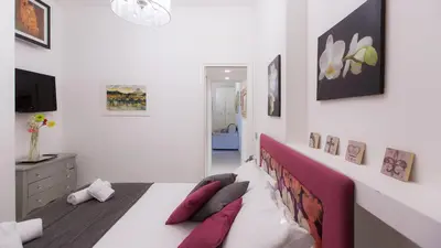 a bedroom with a bed with red and white pillows at Consulta By Rental In Rome in Rome
