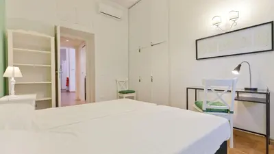 a hospital room with a white bed and a mirror at Circo Massimo Apartment 2 in Rome