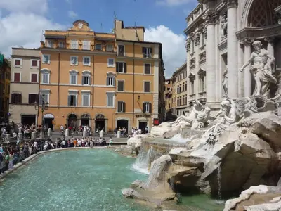 a fountain in a city with people standing around it at Circo Massimo Apartment 2 in Rome
