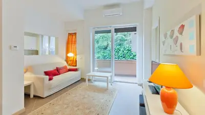 a living room with a white couch and a yellow lamp at Circo Massimo Apartment 2 in Rome