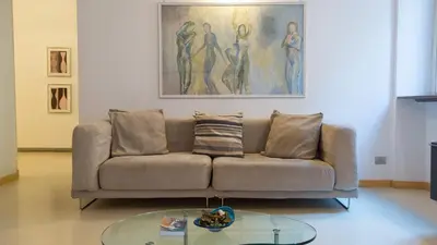 a living room with a couch and a glass table at Rental in Rome Purificazione apartament in Rome