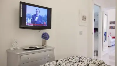 a television hanging on a wall in a living room at Quirinale by Rental in Rome in Rome