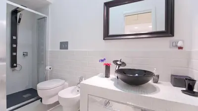 a bathroom with a sink and a toilet and a mirror at Quirinale by Rental in Rome in Rome