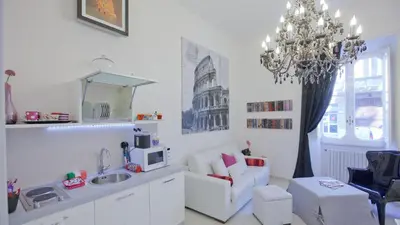 a living room with a couch and a chandelier at Quirinale by Rental in Rome in Rome