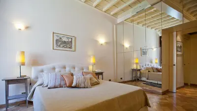 a bedroom with a large bed and a couch at Rental in Rome Trevi Fouintain View Apartment in Rome