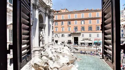 a view of the trevi fountain from a window at Rental in Rome Trevi Fouintain View Apartment in Rome