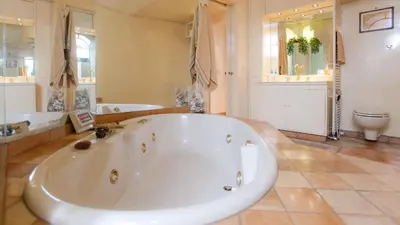 a large bathroom with a large tub and a toilet at Rental in Rome Trevi Fouintain View Apartment in Rome