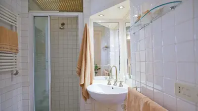 a bathroom with a sink and a mirror at Rental in Rome Trevi Fouintain View Apartment in Rome