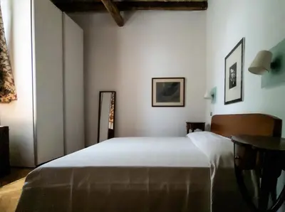 a bedroom with a large white bed and a table at Raffaello Terrace - near Piazza Navona in Rome