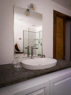 a bathroom with a white sink and a mirror at Raffaello Terrace - near Piazza Navona in Rome