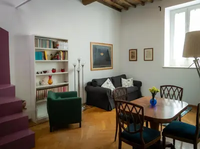a living room with a table and a couch at Raffaello Terrace - near Piazza Navona in Rome
