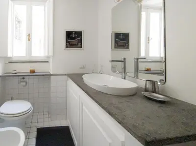 a white bathroom with a sink and a toilet at Raffaello Terrace - near Piazza Navona in Rome