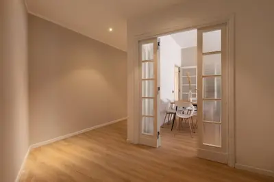 an empty room with a door leading to a dining room at [Ampio appartamento vicino al Vaticano] in Rome