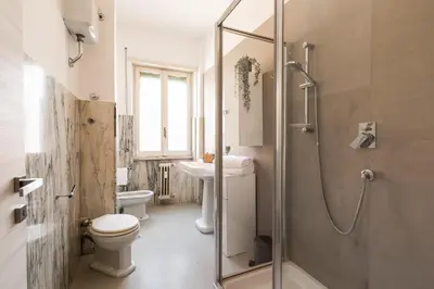 a bathroom with a shower and a toilet and a sink at [Ampio appartamento vicino al Vaticano] in Rome