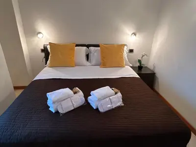 a bedroom with a bed with two pillows on it at Carpegna Luxury apt with terrace in Rome