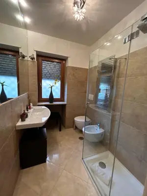 a bathroom with a shower and a sink and a toilet at Carpegna Luxury apt with terrace in Rome