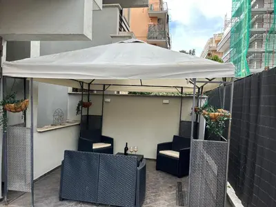 a white umbrella sitting on top of a patio at Carpegna Luxury apt with terrace in Rome