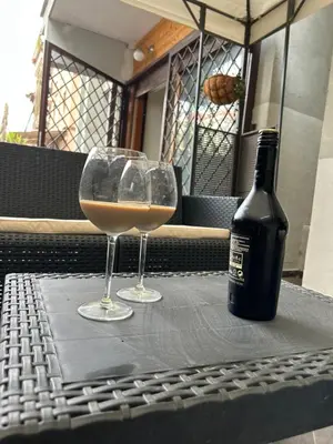 a bottle of wine and two glasses on a table at Carpegna Luxury apt with terrace in Rome