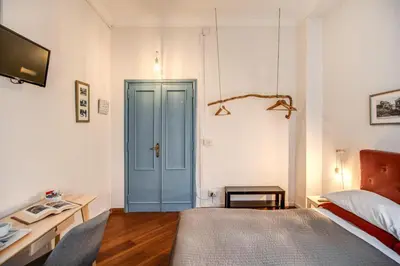 a bedroom with a bed and a blue door at Circus Maximus B&B in Rome