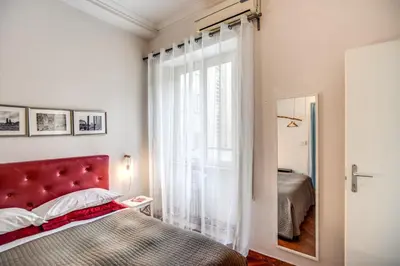 a bedroom with a red bed and a window at Circus Maximus B&B in Rome
