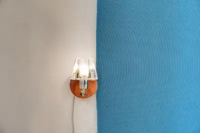 a light on the side of a wall at Circus Maximus B&B in Rome