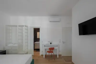 a bedroom with a desk and a red chair at Gianicolense 22 in Rome