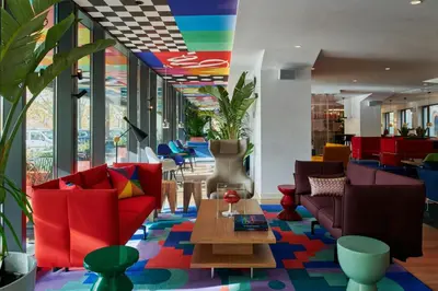 a lobby with colorful furniture and a colorful ceiling at citizenM Rome Isola Tiberina in Rome
