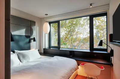 a building with an american flag painted on the wall at citizenM Rome Isola Tiberina in Rome
