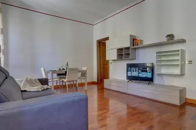 a living room with a couch and a tv at Colosseo Apt Mecenate 77 - Home and More in Rome