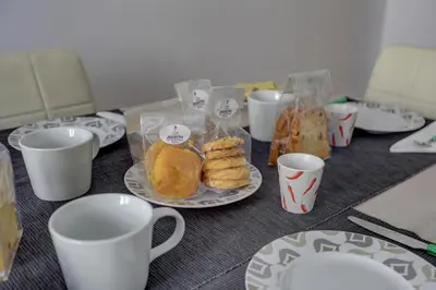 a table with cups and plates and pastries on it at Colosseo Apt Mecenate 77 - Home and More in Rome