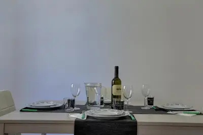 a table with a bottle of wine and glasses at Colosseo Apt Mecenate 77 - Home and More in Rome