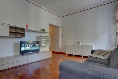 a living room with a couch and a flat screen tv at Colosseo Apt Mecenate 77 - Home and More in Rome