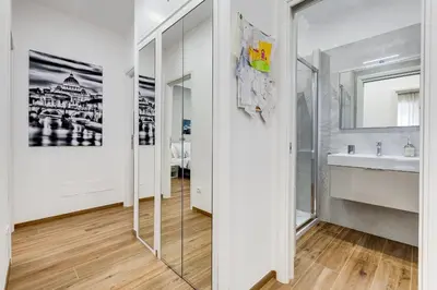 a bathroom with a sink and a mirror at San Pietro Vatican Apartments in Rome