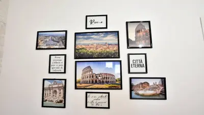 a wall of pictures on a white wall at A due passi da Trastevere in Rome