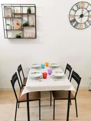 a dining room table with chairs and a clock at A due passi da Trastevere in Rome