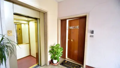 a hallway of a building with a door and a plant at A due passi da Trastevere in Rome