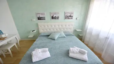 a bedroom with a bed with two pillows on it at A due passi da Trastevere in Rome