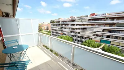 a balcony with a blue chair and a building at A due passi da Trastevere in Rome
