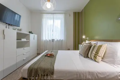 a bedroom with a large white bed and a window at BBHOME Domus aquae inside of appia antica park in Rome