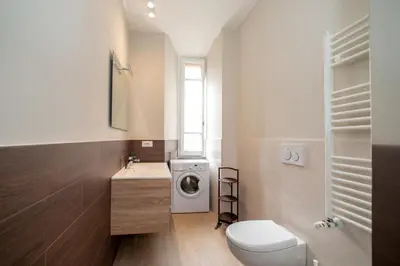 a bathroom with a toilet and a washing machine at Appia96 Apartments in Rome