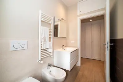 a white bathroom with a sink and a toilet at Appia96 Apartments in Rome