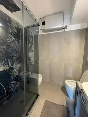 a bathroom with a shower and a toilet at Cozy design studio apartment in Porta Maggiore. in Rome