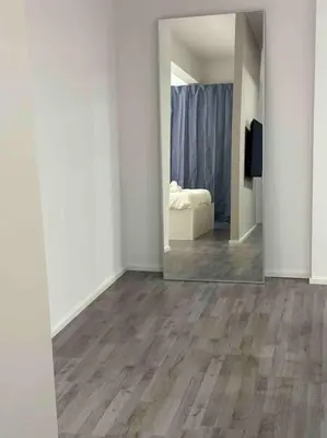 a room with a mirror and a bedroom with a bed at Cozy design studio apartment in Porta Maggiore. in Rome