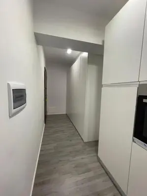 an empty hallway with a microwave and a refrigerator at Cozy design studio apartment in Porta Maggiore. in Rome