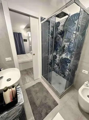 a bathroom with a shower and a toilet and a sink at Cozy design studio apartment in Porta Maggiore. in Rome