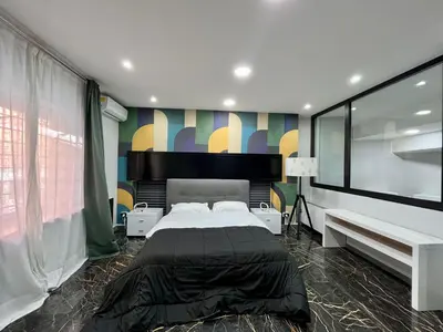 a bedroom with a large bed and a large window at Delizioso appartamento in Rome